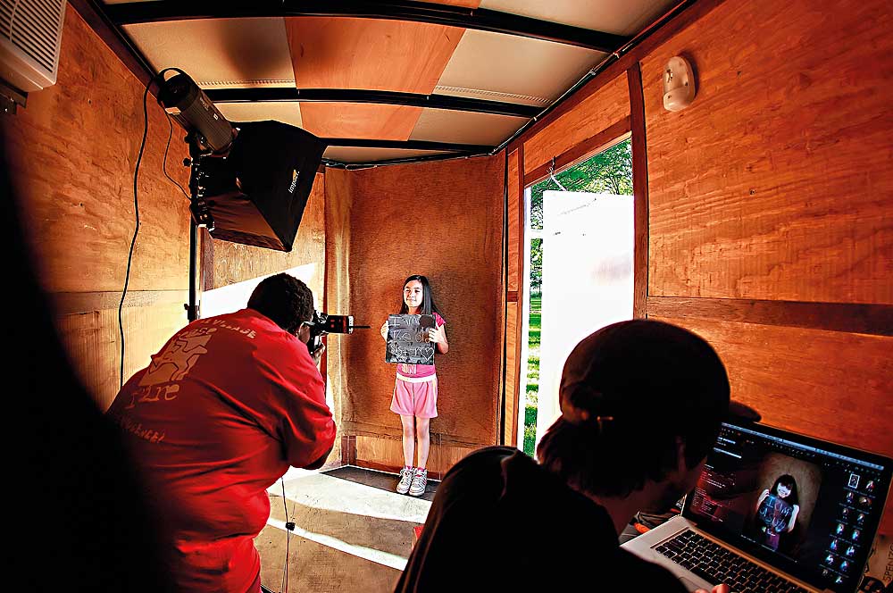 A young community member gets her portrait taken in the mobile photo factory (photo by Ali Zayed)