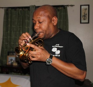 Sanford Mark Barnes, a Saints Tour performer and Braddock resident,  playing the mini-trumpet. (Photo by Tami Dixon)